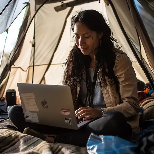 Digital nomad working in a tent